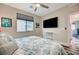 Bright bedroom featuring a ceiling fan, TV, and comfortable interior at 5479 Tamar Ridge Ct, Las Vegas, NV 89141
