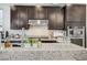 Kitchen featuring a large island, stainless steel range hood, and modern appliances at 5479 Tamar Ridge Ct, Las Vegas, NV 89141
