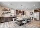 Large island with seating in a modern kitchen with stainless steel appliances and wood floors at 5479 Tamar Ridge Ct, Las Vegas, NV 89141