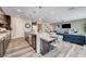 Open kitchen with a large island, pendant lighting, and views of the living area at 5479 Tamar Ridge Ct, Las Vegas, NV 89141