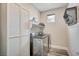 Laundry room with front loading washer and dryer and wire shelving at 5479 Tamar Ridge Ct, Las Vegas, NV 89141