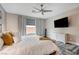 Stylish main bedroom featuring a ceiling fan, modern blinds, and a television at 5479 Tamar Ridge Ct, Las Vegas, NV 89141