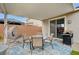 Covered patio with an egg chair, dining table, and grill at 5479 Tamar Ridge Ct, Las Vegas, NV 89141