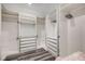 This walk-in closet has wood-look floors and custom shelving and drawers at 5479 Tamar Ridge Ct, Las Vegas, NV 89141