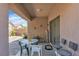 Cozy covered patio with table and chairs, perfect for outdoor dining and relaxation at 6160 Majestic Wind Ave, Las Vegas, NV 89122