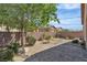 Private backyard with stone landscaping, rock features and a retaining wall at 6160 Majestic Wind Ave, Las Vegas, NV 89122