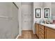 Bathroom featuring wood cabinets, double sinks, and walk-in shower at 6160 Majestic Wind Ave, Las Vegas, NV 89122