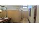 Community center public bathroom featuring multiple stalls, mirrors, and wash basins at 6160 Majestic Wind Ave, Las Vegas, NV 89122
