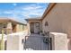 Inviting front porch with iron gate, pavers, and exterior sconces creates a warm welcome at 6160 Majestic Wind Ave, Las Vegas, NV 89122