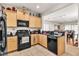 Efficient kitchen with black appliances, granite countertops, and wood cabinets at 6160 Majestic Wind Ave, Las Vegas, NV 89122