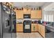 Well-lit kitchen with a black refrigerator and access to the dining area at 6160 Majestic Wind Ave, Las Vegas, NV 89122