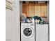 Functional laundry room is equipped with washer, dryer, and overhead cabinets at 6160 Majestic Wind Ave, Las Vegas, NV 89122