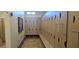 Spacious locker room featuring beige storage lockers, wood-look flooring, and ample bench seating at 6160 Majestic Wind Ave, Las Vegas, NV 89122