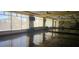 Spacious meeting room featuring shiny wood floors, ceiling fans, and large bright windows at 6160 Majestic Wind Ave, Las Vegas, NV 89122