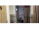 Convenient shower stall featuring tiled walls, safety bars, wood bench, and privacy curtain at 6160 Majestic Wind Ave, Las Vegas, NV 89122