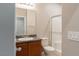 Modern bathroom with a glass enclosed shower, single vanity, a toilet and neutral walls at 6317 Highledge St, North Las Vegas, NV 89081