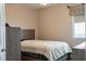 Comfortable bedroom with neutral walls, wood furniture, carpet flooring and a window at 6317 Highledge St, North Las Vegas, NV 89081