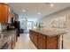 Modern kitchen with an island and lots of cabinet space overlooking living area at 6317 Highledge St, North Las Vegas, NV 89081
