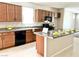 Beautiful kitchen with granite countertops, tile backsplash, stainless steel appliances, and a large island at 6317 Highledge St, North Las Vegas, NV 89081
