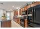 Well-equipped kitchen boasting wood cabinets, granite countertops, and stainless steel appliances including a refrigerator at 6317 Highledge St, North Las Vegas, NV 89081