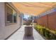 Relaxing covered patio with an outdoor grill and comfortable seating area at 6317 Highledge St, North Las Vegas, NV 89081