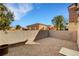 A gravel backyard offering privacy with block wall fencing and a nice view at 644 Chase Tree St, Las Vegas, NV 89144
