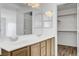 Elegant bathroom with double sinks, large mirror, and access to a walk-in closet at 644 Chase Tree St, Las Vegas, NV 89144