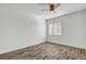 Cozy bedroom with neutral walls, a window offering natural light, and wood-look floors at 644 Chase Tree St, Las Vegas, NV 89144