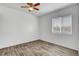 This bedroom has wood floors, natural light, and a ceiling fan at 644 Chase Tree St, Las Vegas, NV 89144