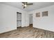 This bedroom offers wood floors, a ceiling fan, a closet, and natural light at 644 Chase Tree St, Las Vegas, NV 89144