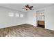 Bright bedroom featuring three windows, ceiling fan, and ensuite bathroom entrance at 644 Chase Tree St, Las Vegas, NV 89144