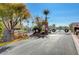 Gated community entrance with mature trees and manicured landscaping at 644 Chase Tree St, Las Vegas, NV 89144