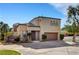 Two-story home with a two-car garage, desert landscaping, and a well-maintained lawn at 644 Chase Tree St, Las Vegas, NV 89144