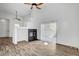 Open-concept living room with a fireplace, wood-look flooring, and natural light at 644 Chase Tree St, Las Vegas, NV 89144
