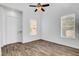 Bright living room with natural light, ceiling fan, and wood-look flooring at 644 Chase Tree St, Las Vegas, NV 89144