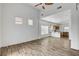 Bright living room boasts wood floors, ceiling fan, and flows into the kitchen at 644 Chase Tree St, Las Vegas, NV 89144