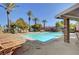 Community pool area with lounge chairs and covered patio at 644 Chase Tree St, Las Vegas, NV 89144