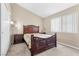 Bedroom features an ornate wooden bed and a large bright window at 6440 High Sierra Ave, Las Vegas, NV 89156