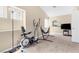 Spacious bonus room with carpet and exercise equipment including an elliptical machine and a hammock at 6440 High Sierra Ave, Las Vegas, NV 89156
