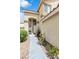 Charming front entrance with a walkway lined with colorful flowerbeds and a cozy bench for relaxing at 6440 High Sierra Ave, Las Vegas, NV 89156