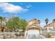 Two-story home with a red tile roof, white iron fence, arched entryway, and a well-maintained landscape at 6440 High Sierra Ave, Las Vegas, NV 89156