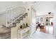 Bright foyer with staircase leading to the second floor and a glimpse into the living room with hardwood floors at 6440 High Sierra Ave, Las Vegas, NV 89156