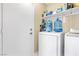 This practical laundry area features a washer, dryer, and shelving for storage at 6440 High Sierra Ave, Las Vegas, NV 89156