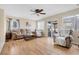 Comfortable living room with hardwood floors, ceiling fan, sliding glass doors, and plush furnishings at 6440 High Sierra Ave, Las Vegas, NV 89156