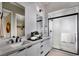 Modern bathroom features double sinks, a walk-in shower with glass door, and sleek fixtures at 647 Spotted Falcon St, Las Vegas, NV 89138