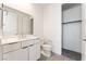 Bright bathroom with modern vanity, open closet, and neutral tile flooring at 647 Spotted Falcon St, Las Vegas, NV 89138