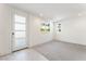 Bright bedroom with large windows, neutral carpet, and a view of the outside greenery at 647 Spotted Falcon St, Las Vegas, NV 89138