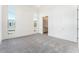 Spacious bedroom with multiple windows, plush carpeting, and an en suite bathroom at 647 Spotted Falcon St, Las Vegas, NV 89138