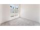 Well-lit bedroom with large windows and neutral colored carpet flooring at 647 Spotted Falcon St, Las Vegas, NV 89138