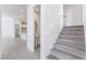 Bright entryway with tile flooring, stairs, and a view of the kitchen and powder room at 647 Spotted Falcon St, Las Vegas, NV 89138